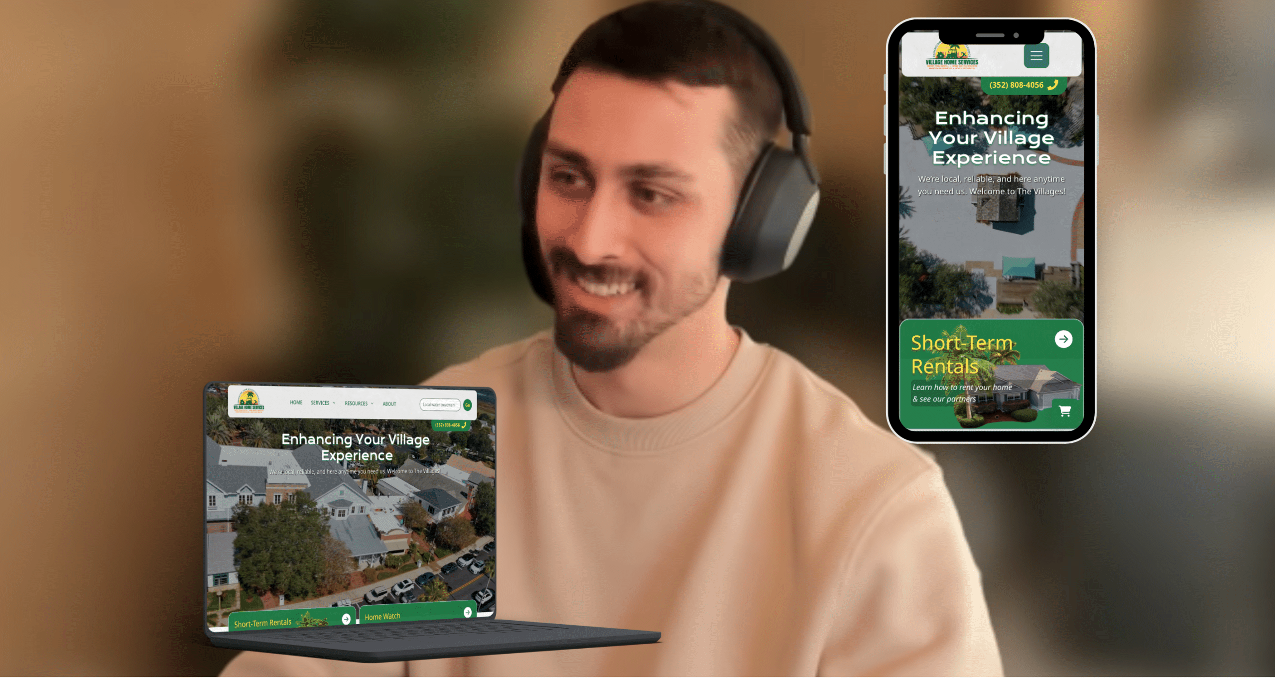 Smiling man wearing over-ear headphones, with a laptop and a smartphone displaying a village services website titled Enhancing Your Village Experience.